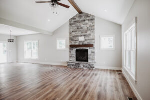 Great room with gray stone fireplace in custom home built in western Ohio.
