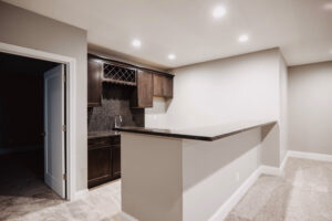 Kitchen with bar in basement of custom home built in western Ohio.
