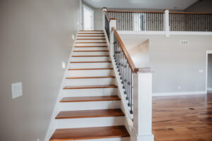 Staircase with iron spindles in custom home located in western Ohio.