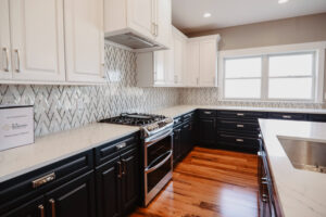 Navy blue and white kitchen cabinets in custom home.