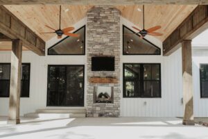 Outdoor fireplace on covered patio in custom home in near Tipp City, Ohio