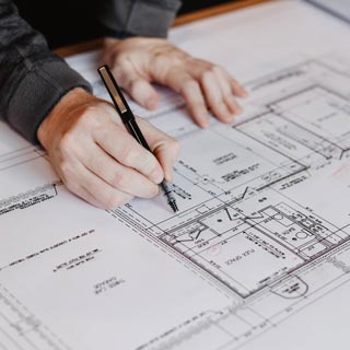 Draftsman drawing custom home blueprint
