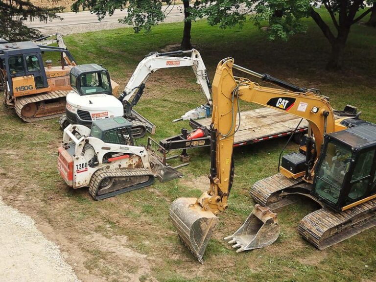 Excavating equipment parked at new home building site.